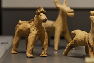 Antique children's toy, Handmade clay figure of a horse from historical times in close-up,