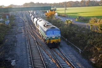 Diesel locomotive freight train on the West Coast mainline at Woodborough, Wiltshire, England, UK