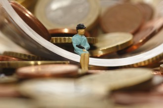 Miniature woman with euro coins, North Rhine-Westphalia, Germany, Europe