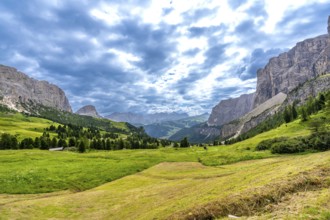 Stunning landscape of the italian dolomites, featuring the gardena pass winding through lush