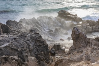 Sea water lashes over the eroded rocks on Salines beach, Ibiza, Balearic Islands, Mediterranean