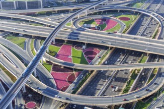 Intersection of Sheikh Zayed Road traffic on the road near the Burj Khalifa with Metro in Dubai,