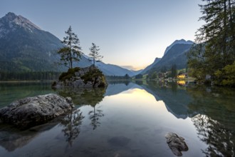 Rocky island with two trees in the lake, reflection in Hintersee, at sunset, Berchtesgaden National