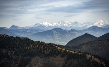 View of the Alpine foothills and main Alpine ridge with snow-covered peaks, summit of the Hohe