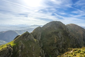 Hikers enjoy the stunning panoramic view from the summit of aiako harria, also known as penas de