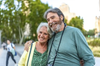 Close-up of smiling caucasian senior couple embracing visiting a city on holidays