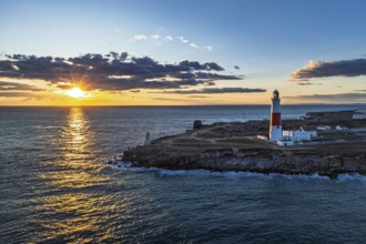 Sunset over Portland Bill Lighthouse from a drone, Portland Bill, Isle of Portland, Dorset,