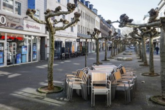 Deserted shopping street with closed shops due to corona pandemic contact ban, main street in the