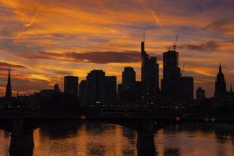 The silhouette of Frankfurt's banking skyline stands out against the luminous evening sky in the