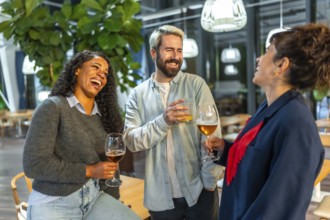 Multi-ethnic friends having fun drinking beer and chatting on an outdoor night bar terrace