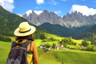 Woman with a backpack enjoying the serene summer landscape of santa maddalena village in val di