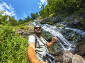 Selfie of a tourist man in summer at the Todtnau waterfall in the Black Forest in Germany