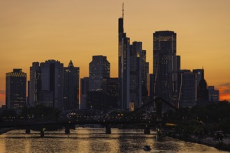 The lights of Frankfurt's banking skyline begin to glow in the evening after sunset, Frankfurt am