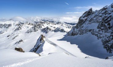 Mountain ridge of Piz Kesch, ascent on Piz Kesch or Piz d'Es-cha in winter, spectacular mountain