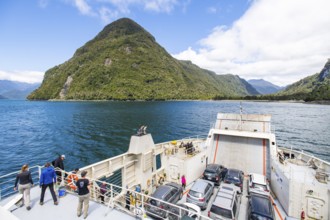 Passengers view the mountains and fjord landscape on the car ferry between Hornopirén and Caleta