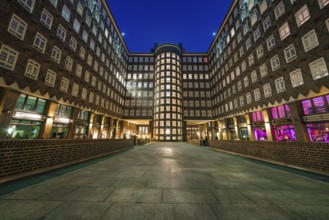 Building in symmetrical perspective with illuminated windows in the evening, Hamburg, Germany,