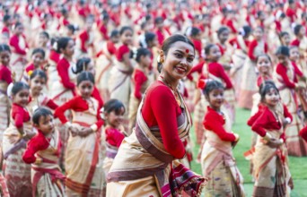 An instructor dance as participants follows the dance step in a Bihu dance workshop ahead of