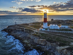 Sunset over Portland Bill Lighthouse from a drone, Portland Bill, Isle of Portland, Dorset,