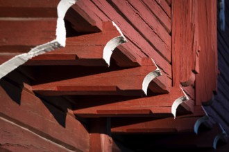Detail of falun red painted wooden construction, detail of traditional Norwegian wooden granary or