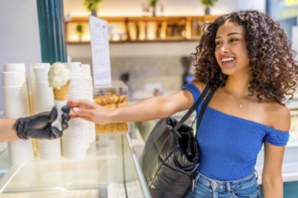 Side view of a happy latin beauty woman shopping ice cream cone at store