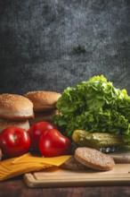 Fresh ingredients for a hamburger, including lettuce, tomatoes and bun
