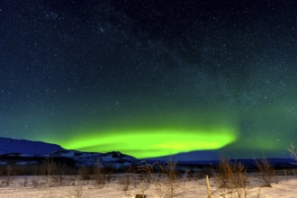 A beautiful Northern Lights in the cold Icelandic winter at night. Concept of Aurora Borealis on