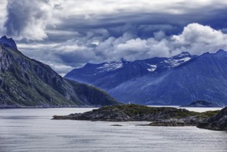 Dramatic fjord landscape with mountains and clouds under a stormy sky, Norway, Europe