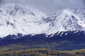 Snow-capped mountains of the Fuegian Andes with a hint of autumn landscape in Ushuaia against an