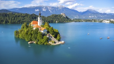 Aerial view of lake bled island with pilgrimage church of the assumption of maria on a sunny summer