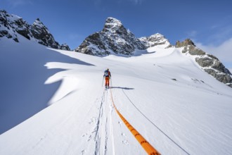 Ski tourer with rope, rope team on the Vadret da Porchabella glacier on the ascent to the summit of