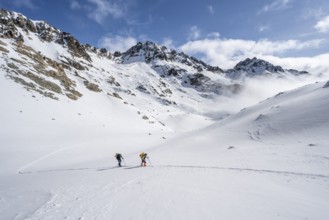 Ski tourers in a wintry mountain landscape, ascent to Porta d'Es-cha, Grisons Haute Route ski tour,
