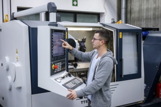 Remscheid, North Rhine-Westphalia, Germany - Trainee in metalworking, here at a CNC machine tool,