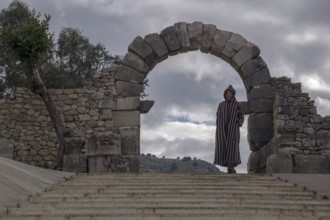 Man with djellab in the ruins of Volubilis, UNESCO World Heritage Site, Mulay Idris, Meknes,