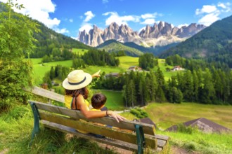 Tourists enjoying breathtaking views of the italian alps in the picturesque val di funes, with the