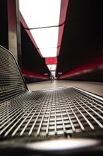 Modern underground station with metal bench and red lighting effects, Hafencity University,
