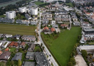Drone image, grassland between built-up residential area, residential buildings and high-rise