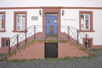 Entrance with staircase to the historic Old Town Hall built in 1717, inscription, red building,