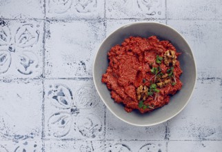 Mahammara red pepper sauce, with walnuts, and sprigs of fresh microgreens, homemade, no people