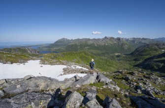 View of mountains and fjord landscape, mountain panorama, mountaineer at the summit of Rundfjellet,