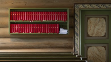 Rule with red hymn books, wooden church, Kvam, Gudbrandsdalen, Norway, Europe
