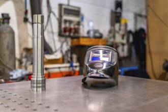 A welding helmet on a factory table with no people