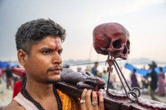 A Hindu priest arrives awith a human skull on the bank of Brahmaputra river on Ashoka Ashtami