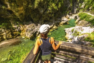 Woman admiring the clear water of tolmin gorges in slovenia, a popular tourist destination in