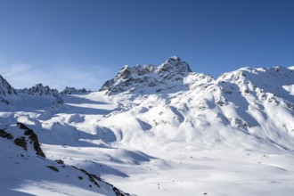 Mountain peak Piz Kesch with snow, view at the Kesch hut in winter, Grisons Haute Route, Albula