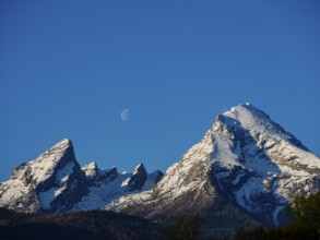 Snow-covered Watzmann, above it a crescent moon in a cloudless sky, Schönau am Königssee,