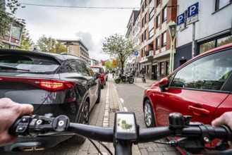 Cycling in the city, inner-city street, cycle lane, bicycles have priority, two-lane traffic with