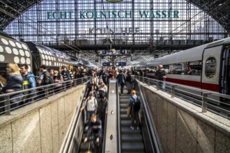 Cologne Central Station, escalators to and from the platform, passengers waiting for the train,