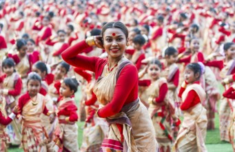 An instructor dance as participants follows the dance step in a Bihu dance workshop ahead of