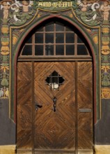 Historic wooden door with carvings on the half-timbered house Lange Bank from 1889 in the Old Town,
