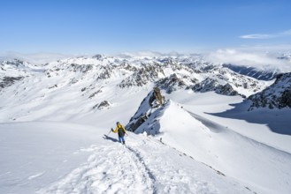 Mountaineer with ice axe and crampons, descent through steep snowfield on Piz Kesch or Piz d'Es-cha
